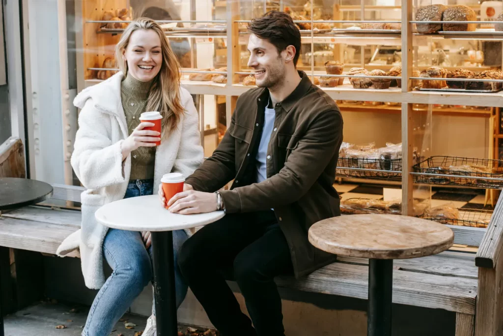 Couple sitting at a café talking together during premarital counselling and assessment